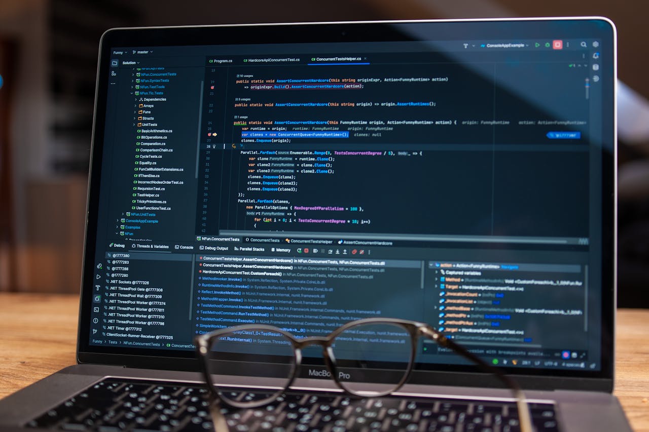 services-02 Laptop screen showing debugging software with code, perfect for tech and software development themes.
